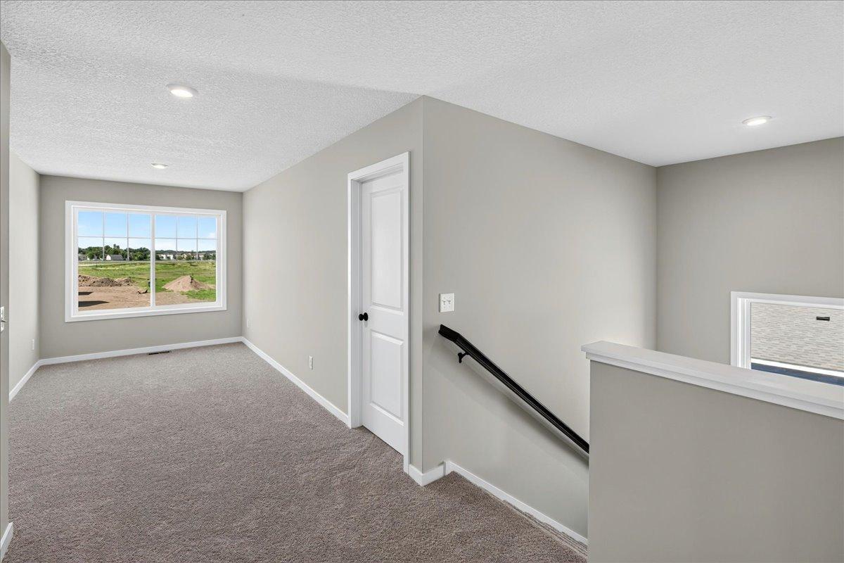 PHOTO OF A DIFFERENT HOME WITH SIMILAR PLAN AND FINISHES. Upper Floor Versatile Loft.