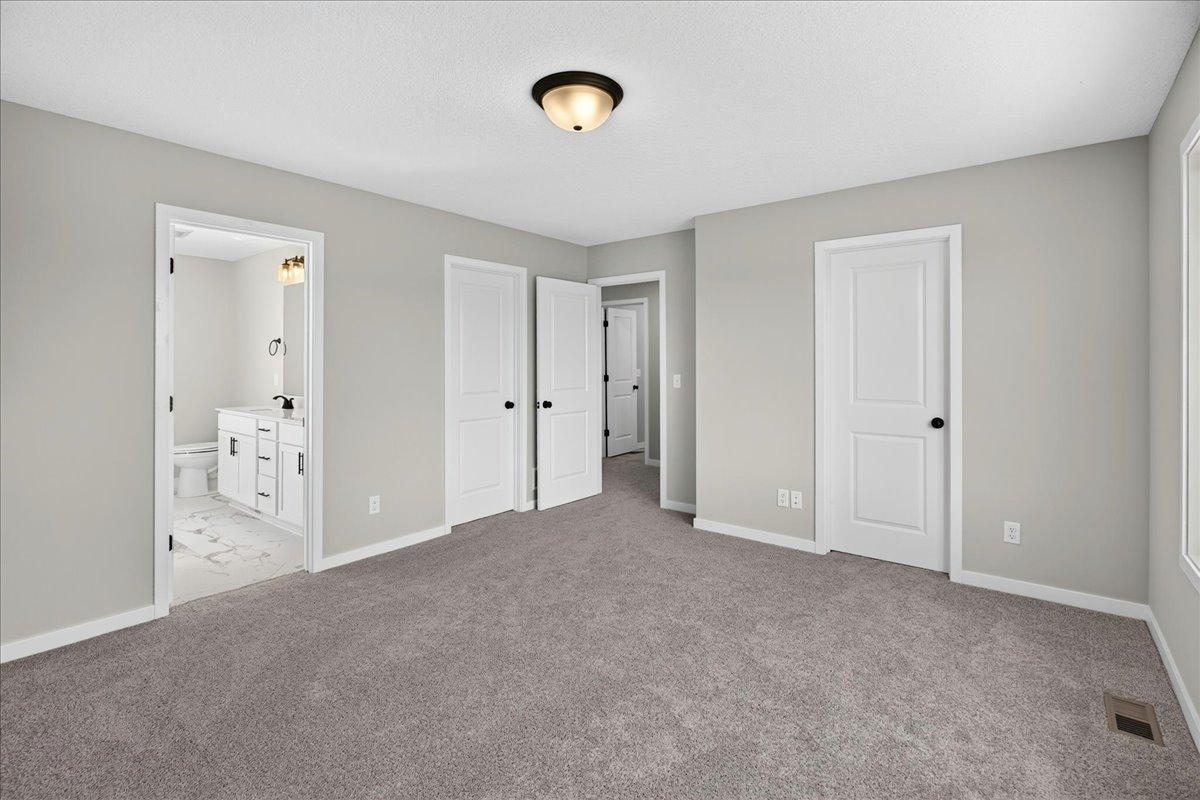 PHOTO OF A DIFFERENT HOME WITH SIMILAR PLAN AND FINISHES. Primary Suite.