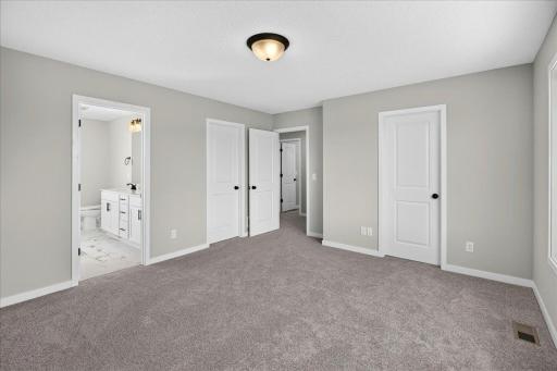 PHOTO OF A DIFFERENT HOME WITH SIMILAR PLAN AND FINISHES. Primary Suite.