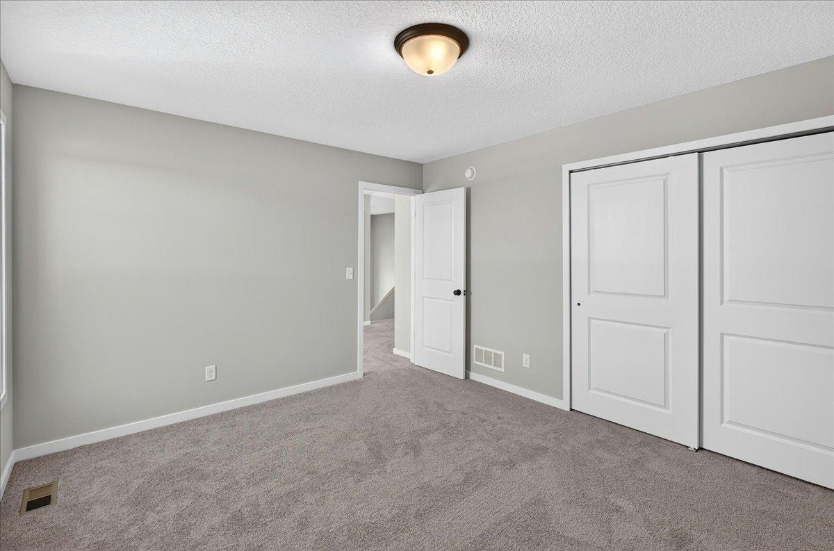 PHOTO OF A DIFFERENT HOME WITH SIMILAR PLAN AND FINISHES. Bedroom 2.