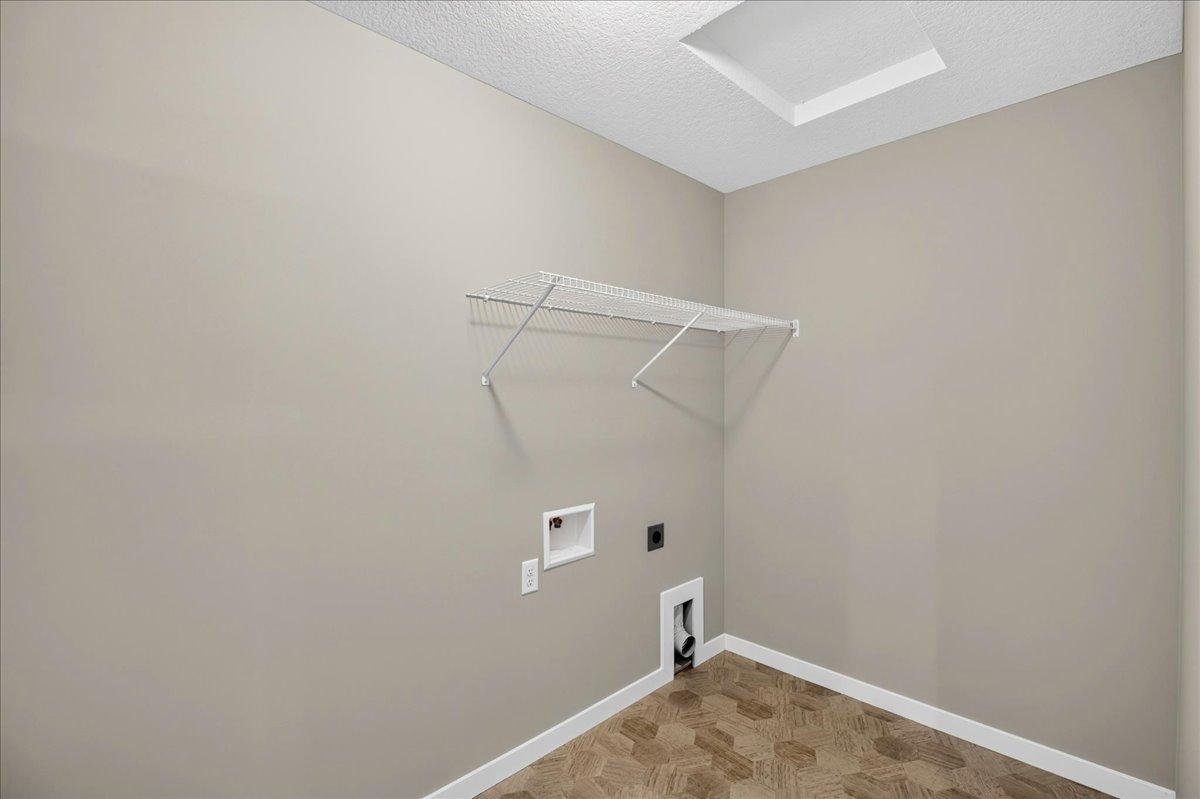 PHOTO OF A DIFFERENT HOME WITH SIMILAR PLAN AND FINISHES. Upper Floor Laundry Room.