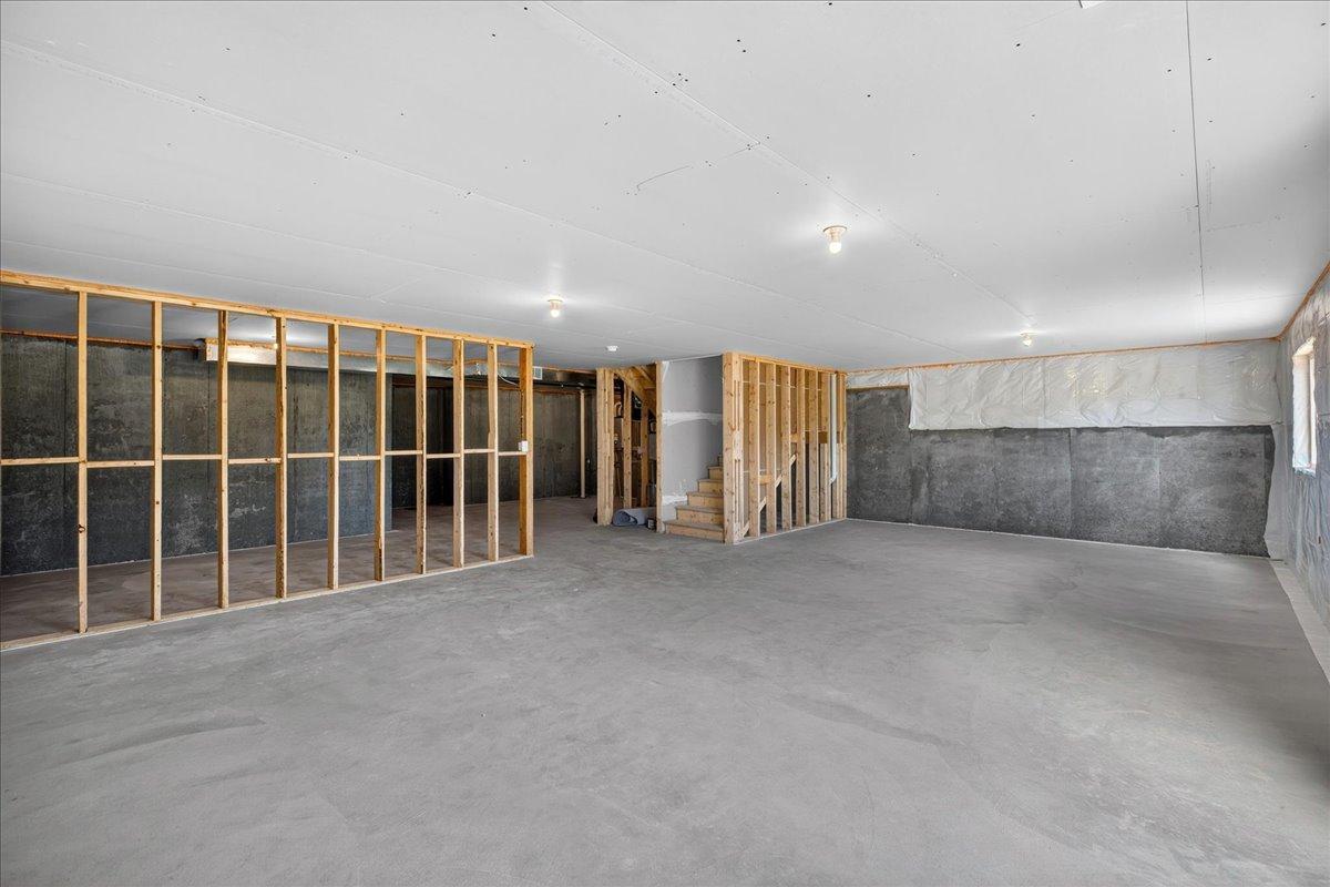 PHOTO OF A DIFFERENT HOME WITH SIMILAR PLAN AND FINISHES. Unfinished Walkout Lower Level.