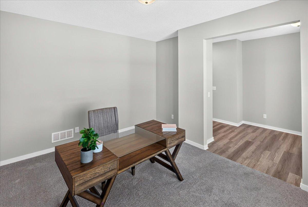 PHOTO OF A DIFFERENT HOME WITH SIMILAR PLAN AND FINISHES. Flex Room.