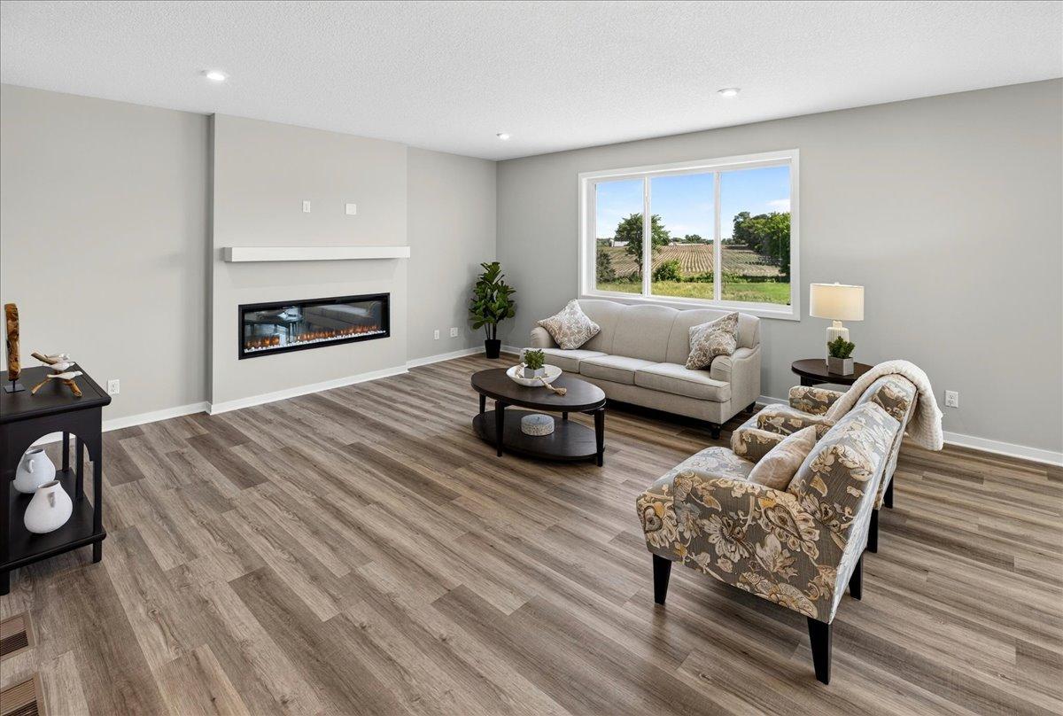 PHOTO OF A DIFFERENT HOME WITH SIMILAR PLAN AND FINISHES. Great Room.