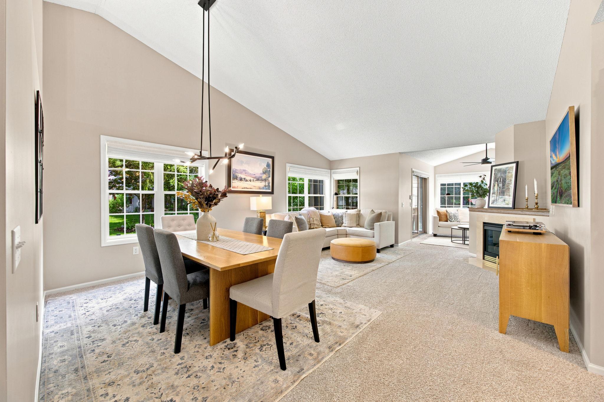 Dining area flows into the living room and features a vaulted ceiling.
