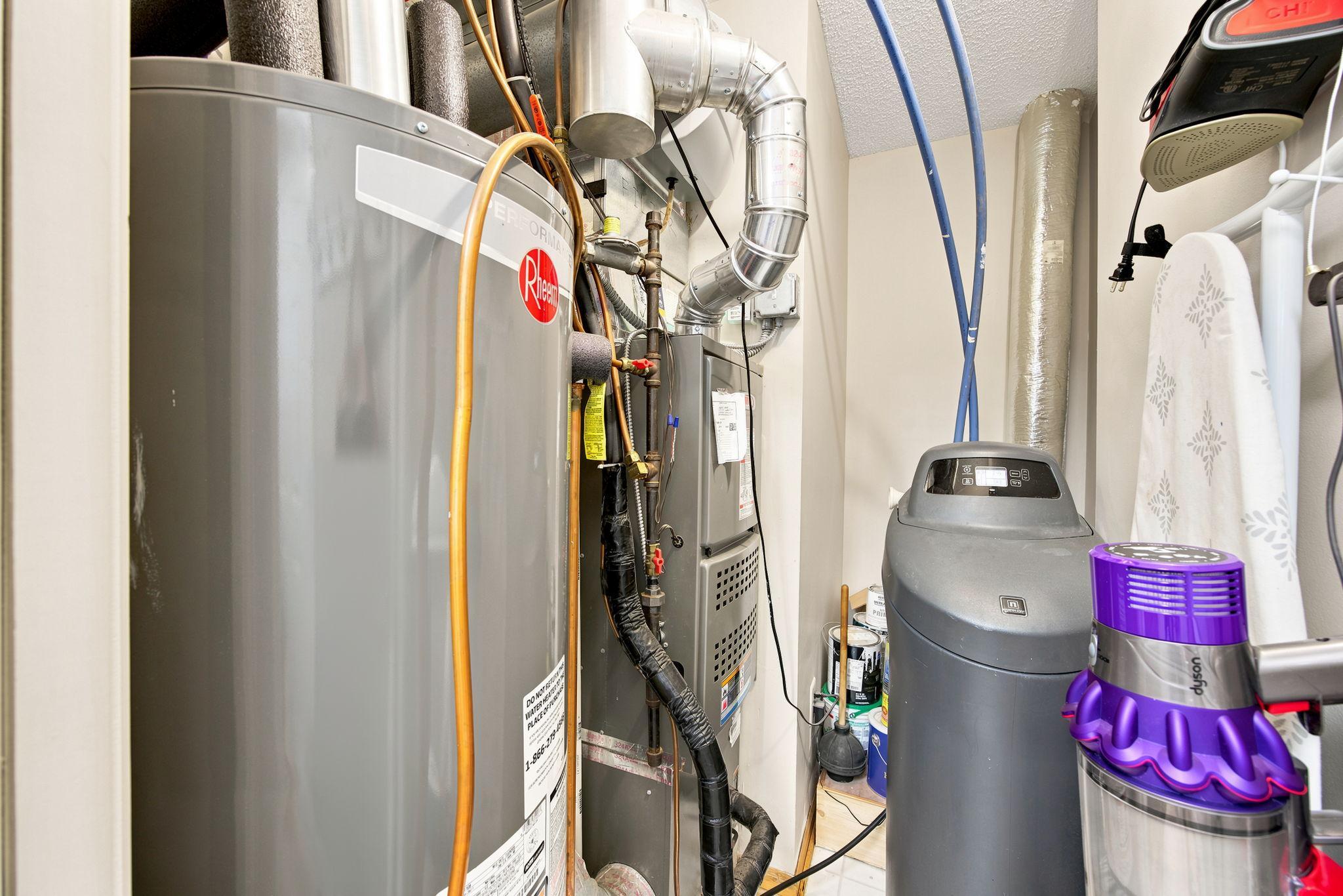 Open the pocket door to expose the new furnace, water heater and owned water softener.