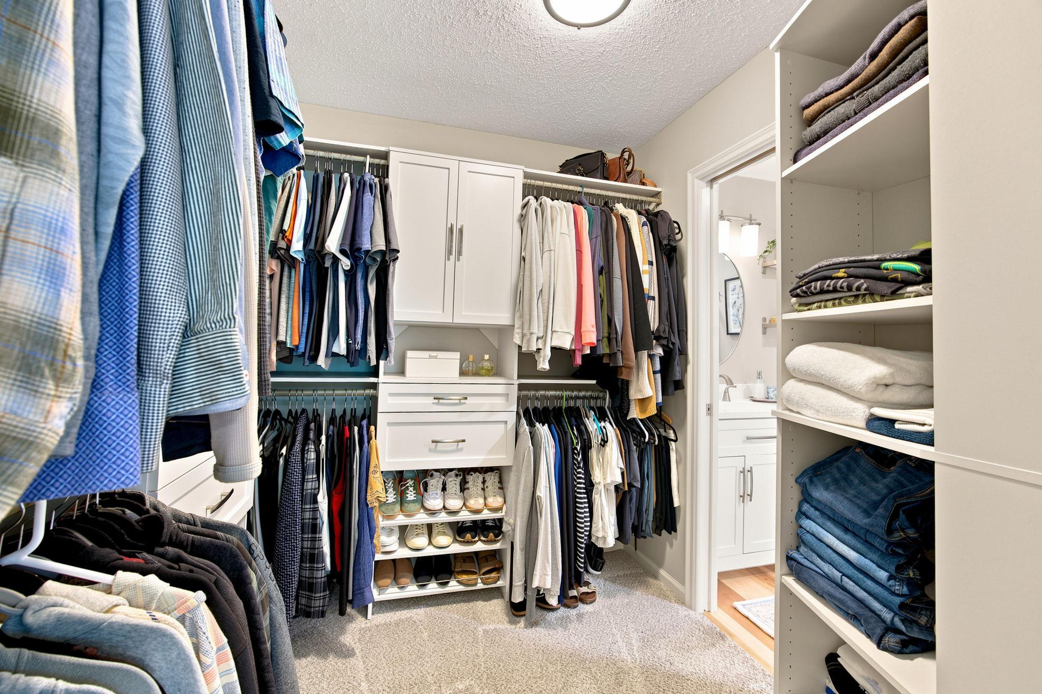 Main bedroom walk-in closet showing off the closet organizer.