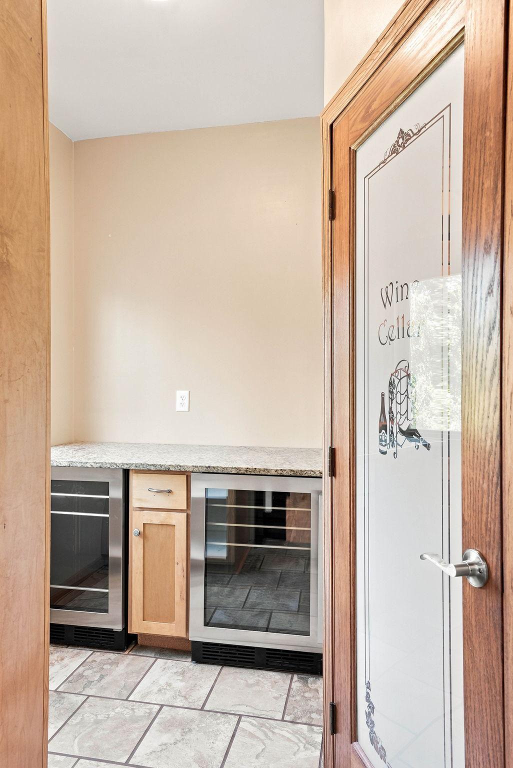 Slide the track door off the dining room to reveal a butlers pantry and custom wine cellar