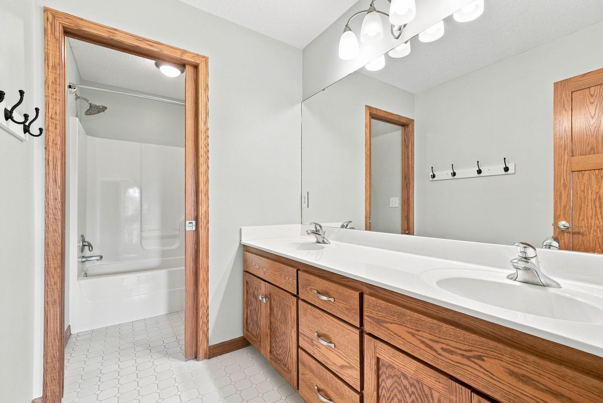 Upper level full bathroom with dual vanity and private shower