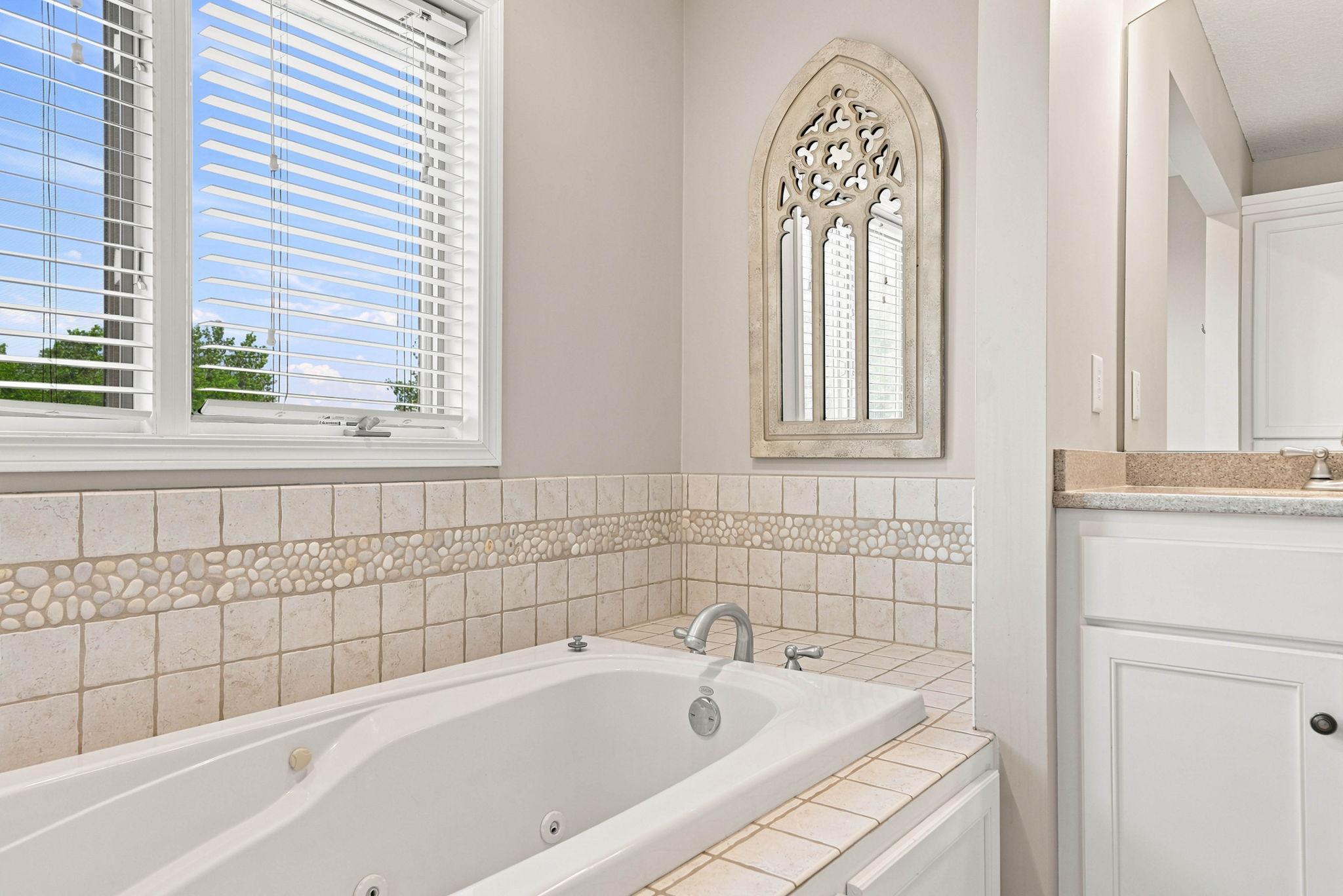 Enjoy this relaxing jetted tub inside the primary suite