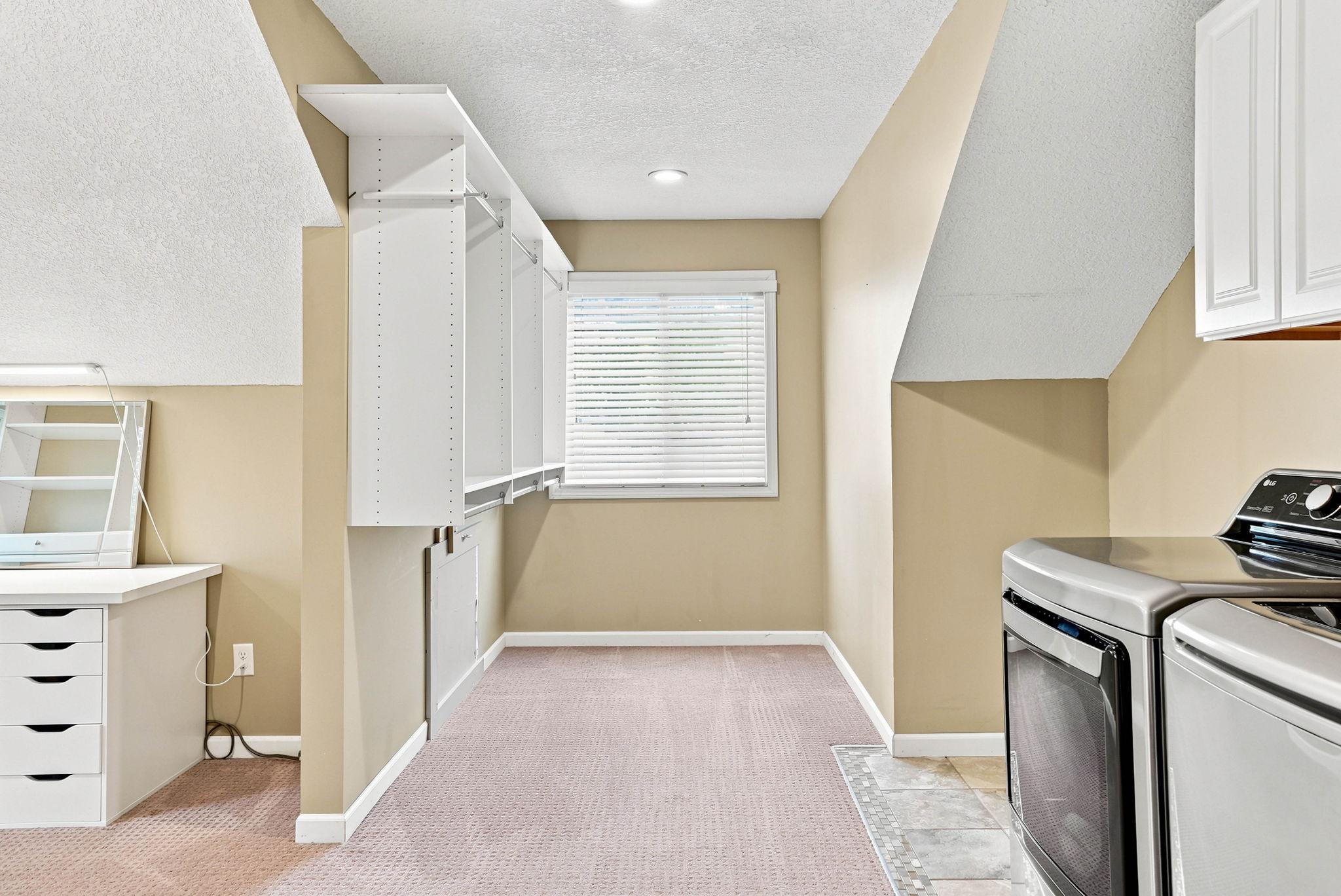 step down into the third section of this amazing walk in closet and 2nd laundry area