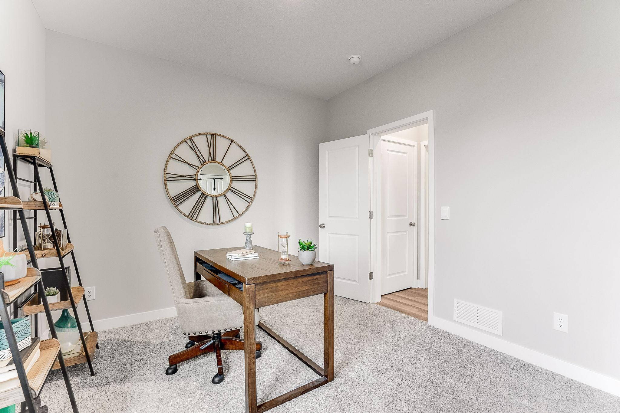 This main level bedroom could be used as an office, den, playroom, spare bedroom, workout room, den! *Photo is of a model home.