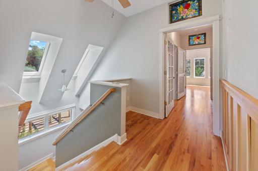 Upstairs is also filled with natural light, hardwood floors, stained glass and more.