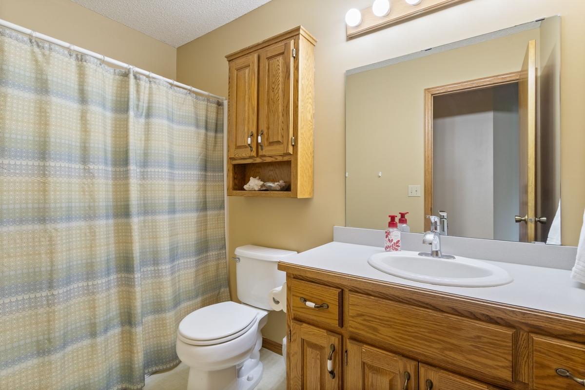 Full bathroom off hallway in upper level