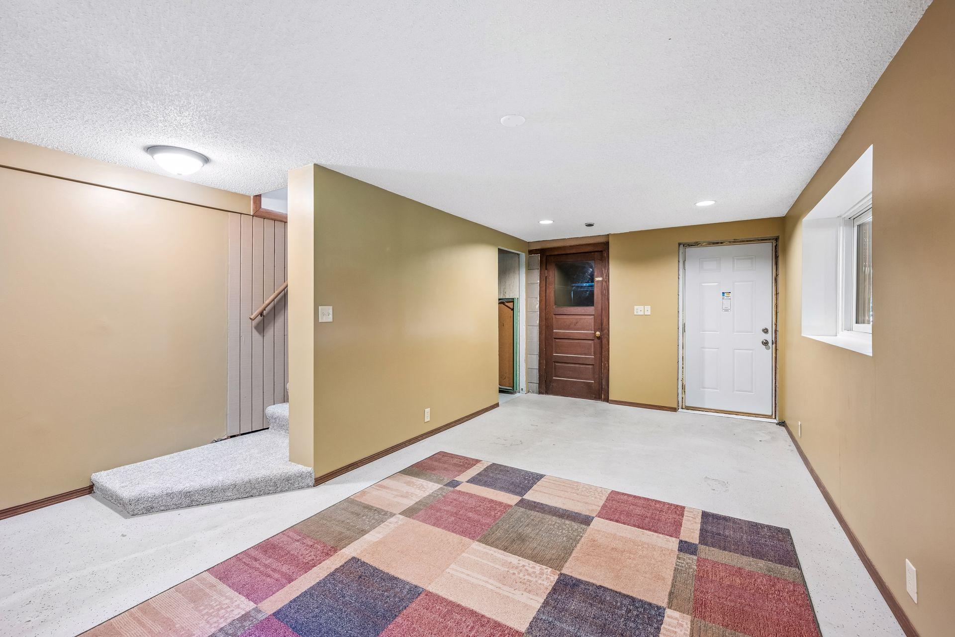 Door to the tuck under garage & the walkout door
