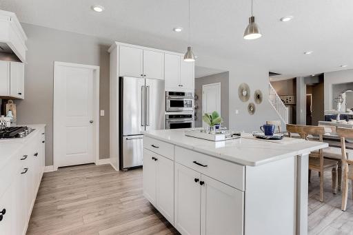This space will make meal preparation a pleasure not a task. Take note of the double-wall ovens!!! Photo of model home, color & options may vary.