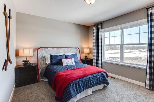 Each of the home's secondary bedrooms on the upper level come perfectly sized and all feature their own private walk-in closet. Photo of model home, color & options may vary.