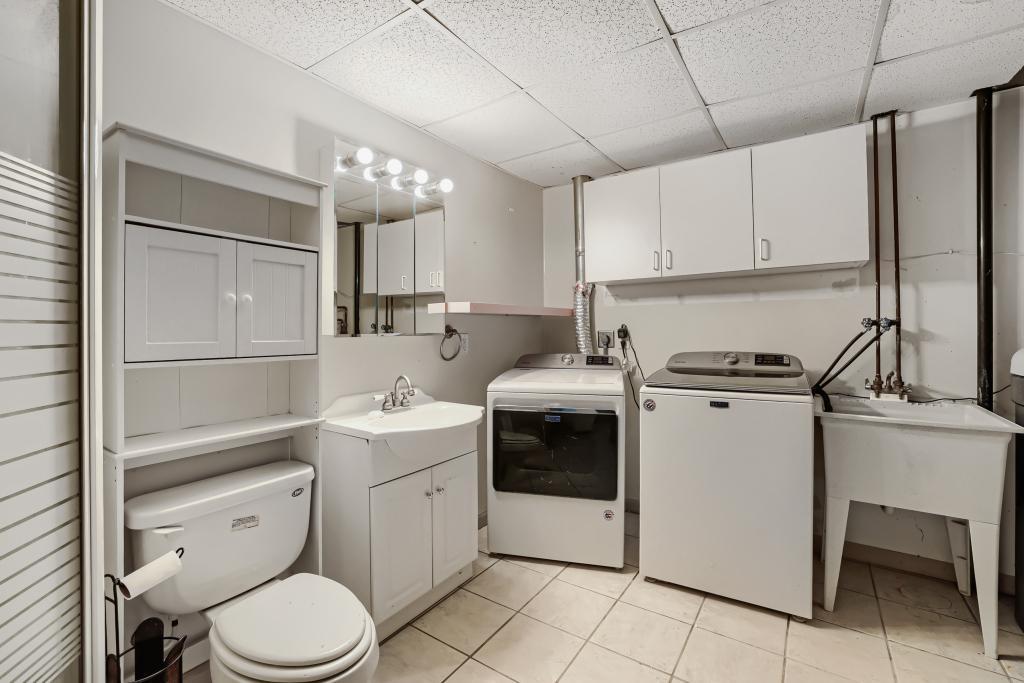 Lower-level laundry room that shares space with 3/4 bath