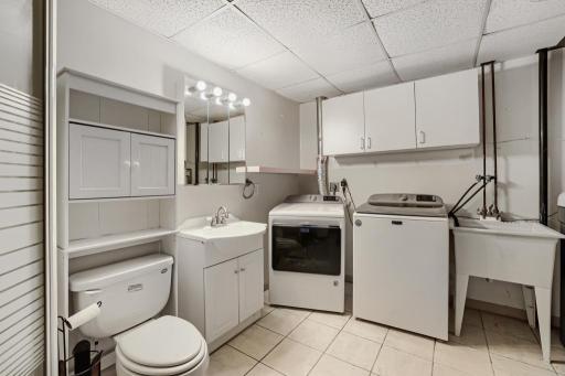 Lower-level laundry room that shares space with 3/4 bath