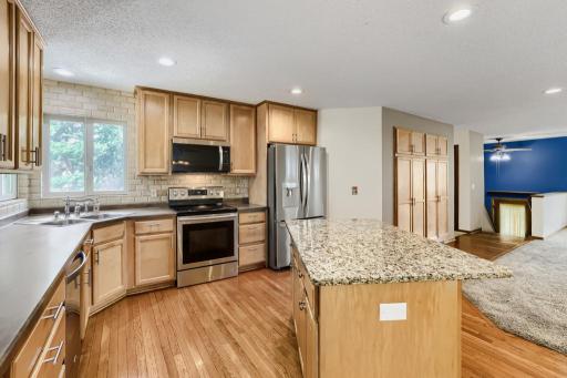 Kitchen with stainless steel appliances, breakfast area & plenty of cupboard space