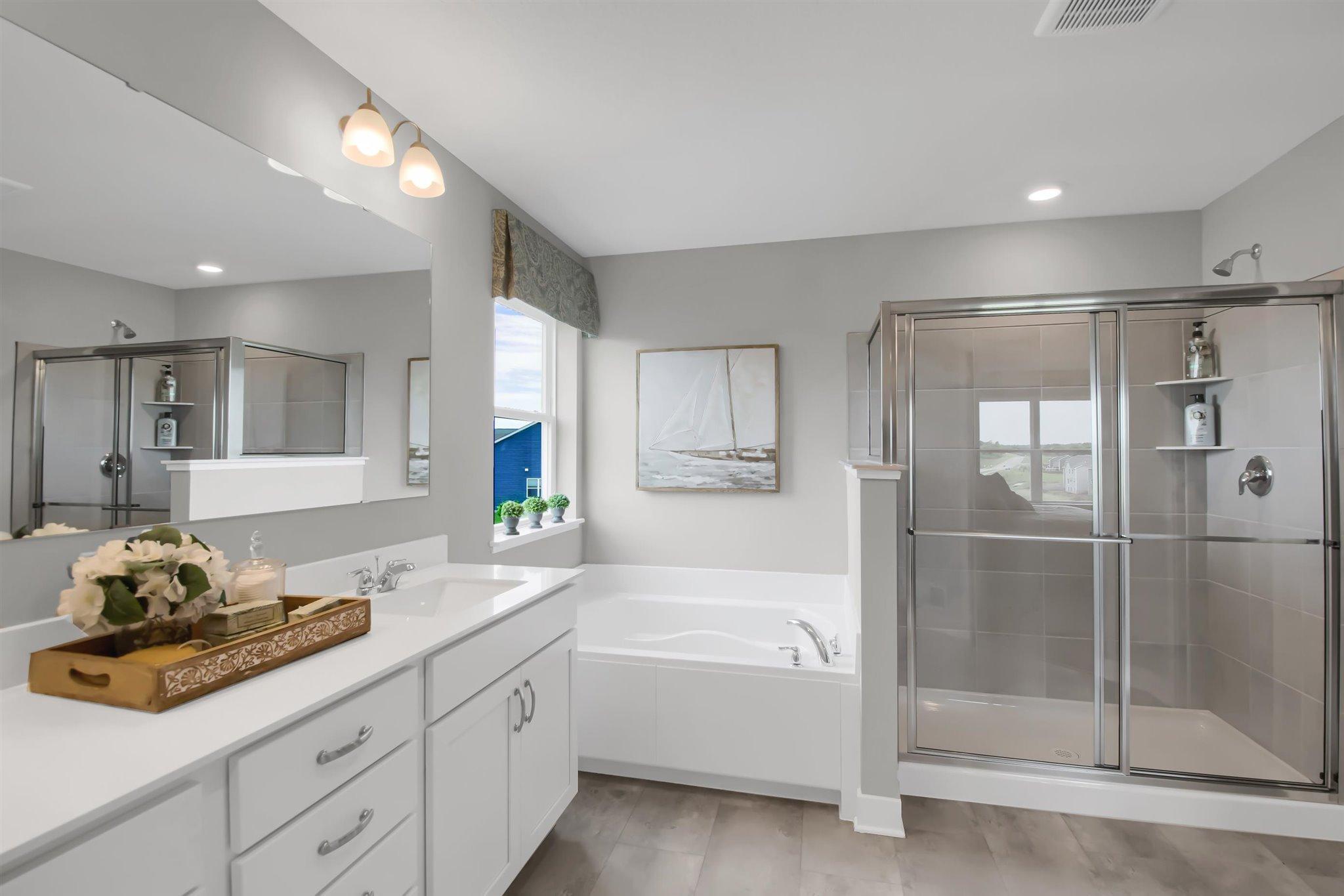Soaker tub and separate tiled shower (colors and options vary).