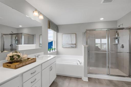 Soaker tub and separate tiled shower (colors and options vary).