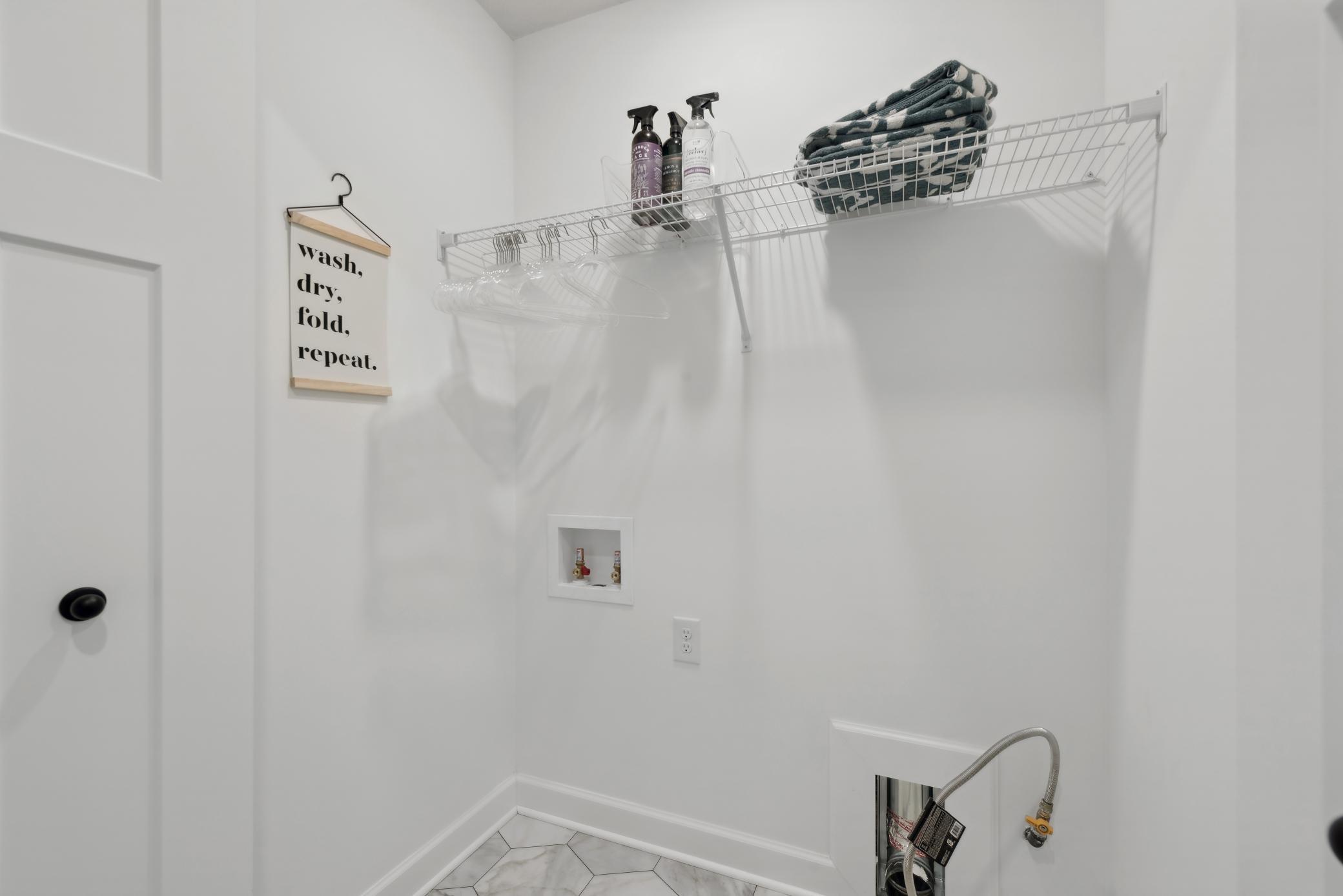 (Photo of a decorated model, actual homes finishes will vary) Centrally located on the upper level, along with the three bedrooms, this laundry room is sure to provide the ultimate convenience.