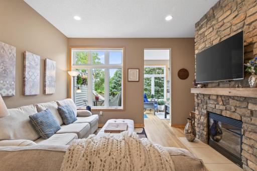 Roomy main floor great room with cozy fireplace with stone surround