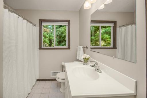 Bright and roomy, this full bathroom is convenient to upper level bedrooms