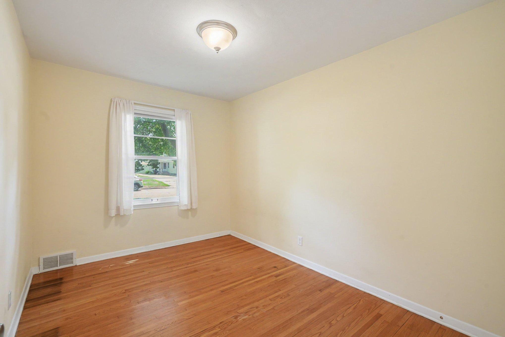 2nd bedroom with hardwood floors & fresh paint, ready to move in!