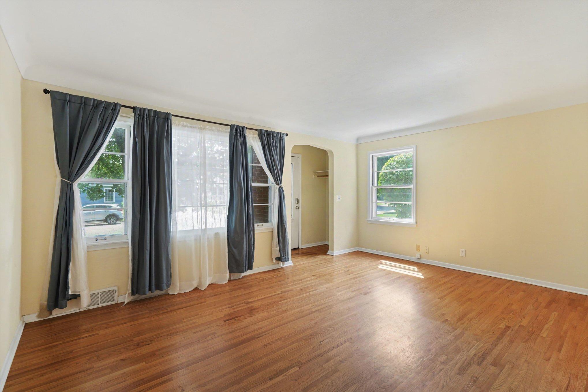 Large living room with great natural light, beautiful hardwood floors, and freshly painted, ready to move in!