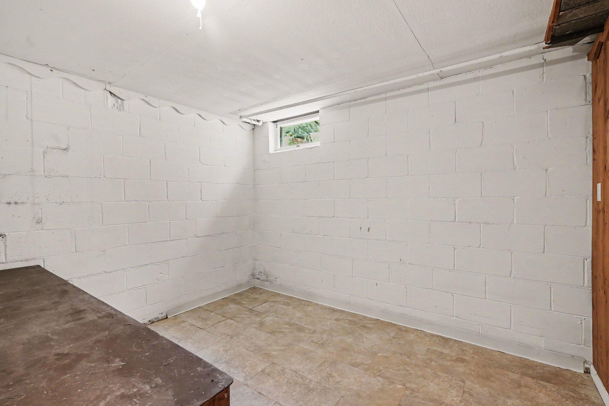 Large storage room in the lower level with built-in workbench.