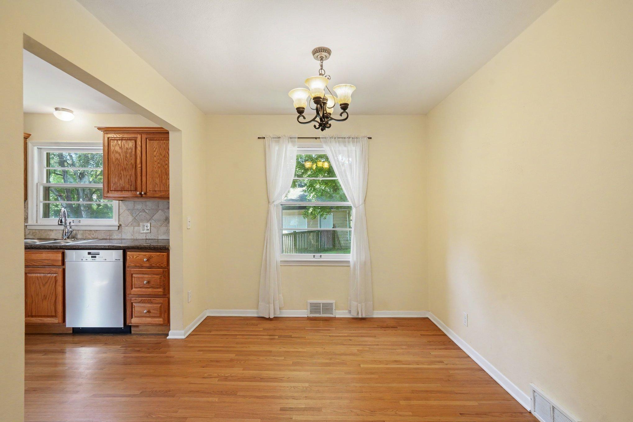 This bright and airy dining room showcases the thoughtful layout of the rambler floor plan. Featuring gorgeous hardwood floors, is freshly painted, and is open to the kitchen for ease of entertaining!