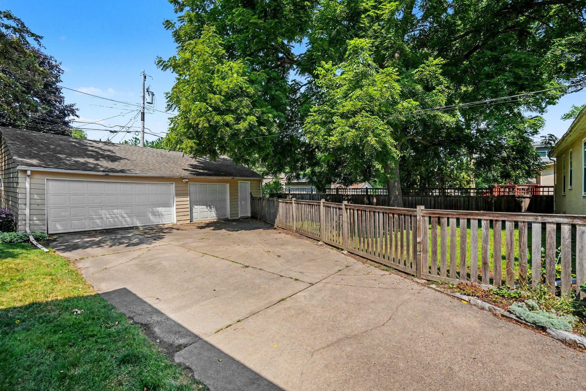 Massive detached garage that offers 3-car capacity with multiple garage doors & a new service door entrance. Fully fenced-in backyard provides secure green space ideal for pets, play, gardening & relaxing summer evenings!