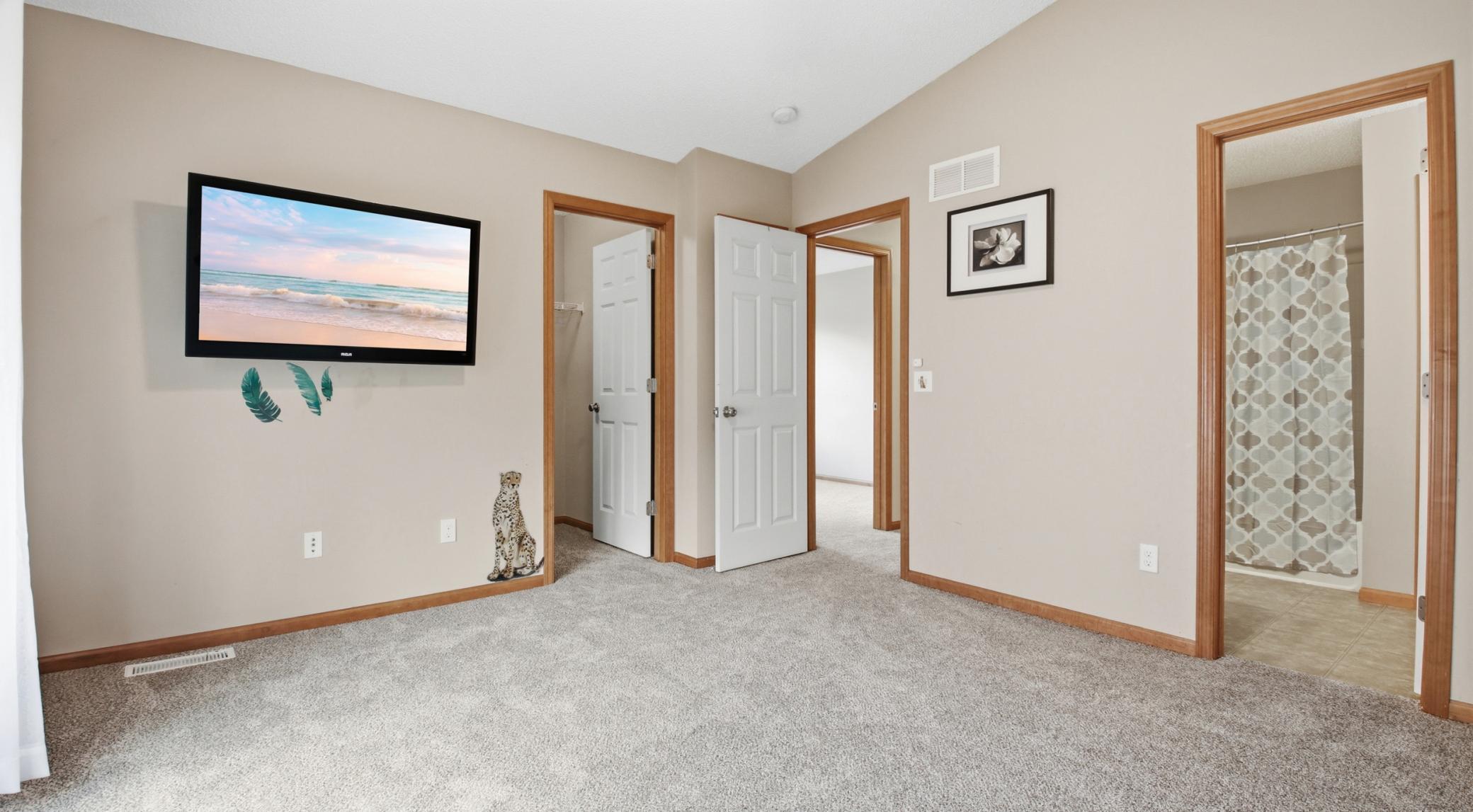 Another view of the primary bedroom. Just behind the door to the hall is a bonus linen closet!