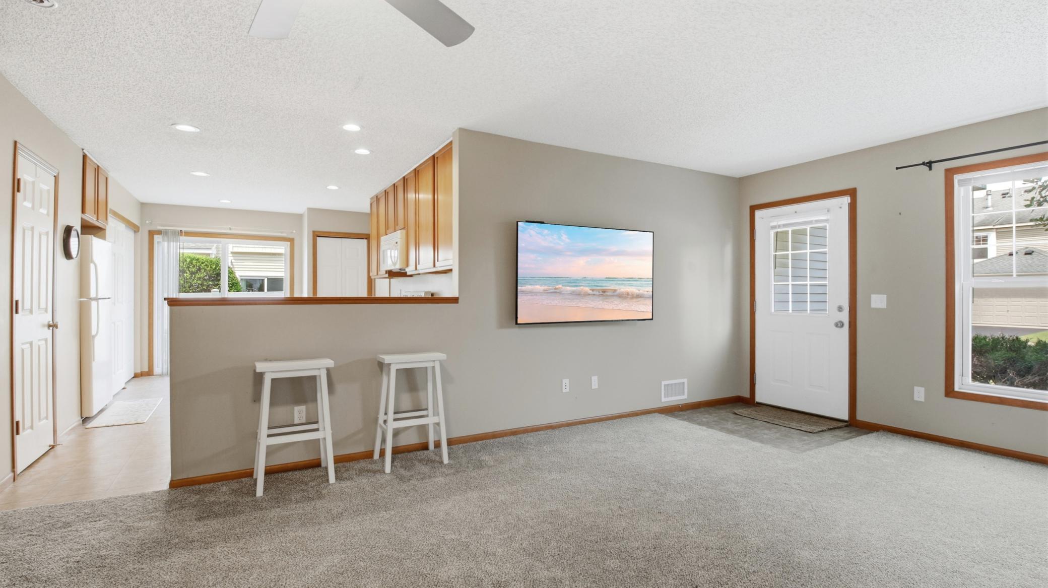 A look toward the kitchen and the front entry with easy-to-clean ceramic tile.