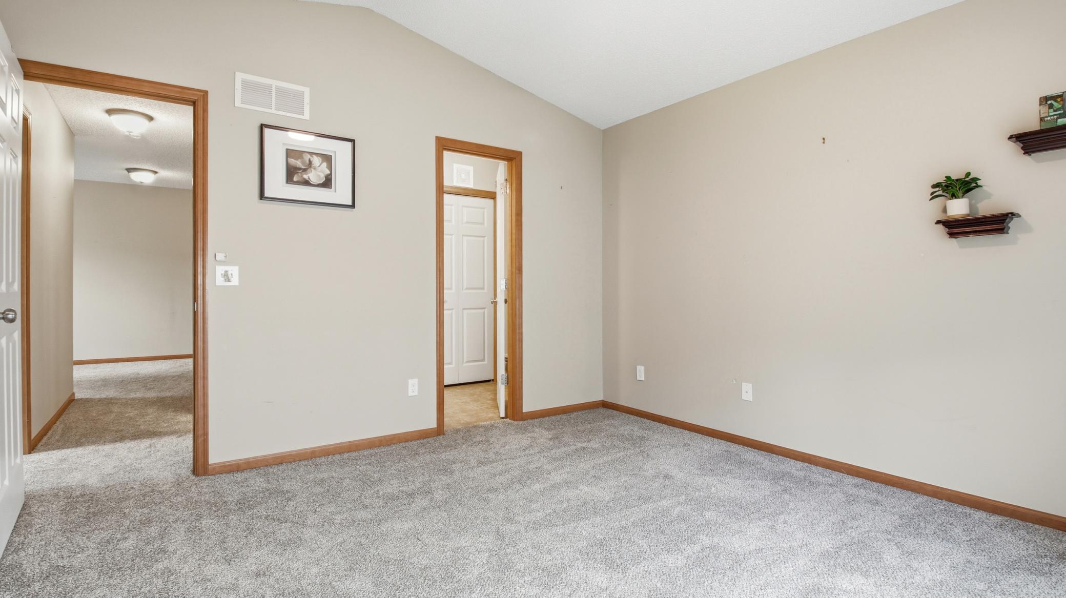 Pass-through door to the bathroom. A good view of the new carpet installed throughout the upper level.