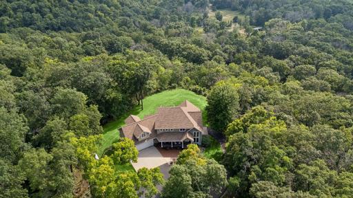 Stunning property nestled on close to 4.5 acres of wooded serenity