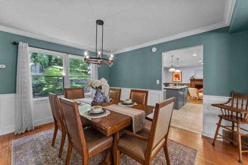 Beautiful backyard views, detailed wainscoting, statement lighting, and plenty of space.