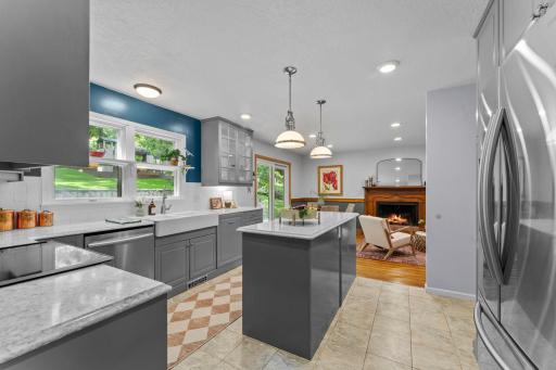 The kitchen balances function with character, featuring stainless steel appliances and plentiful cabinetry.