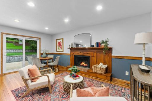 The family room becomes a natural place to unwind, centered around a classic wood-burning fireplace.