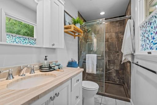 Beautiful tiled walk-in shower and vanity for added storage.