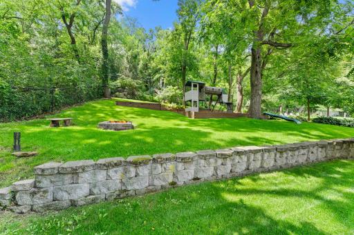 Fully fenced and framed by mature trees, the tiered landscape creates depth, privacy, and endless opportunities to enjoy the outdoors.