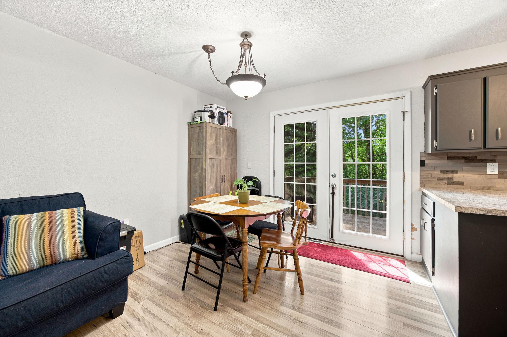 French doors bring in natural light and connect the dining area to the outdoors.