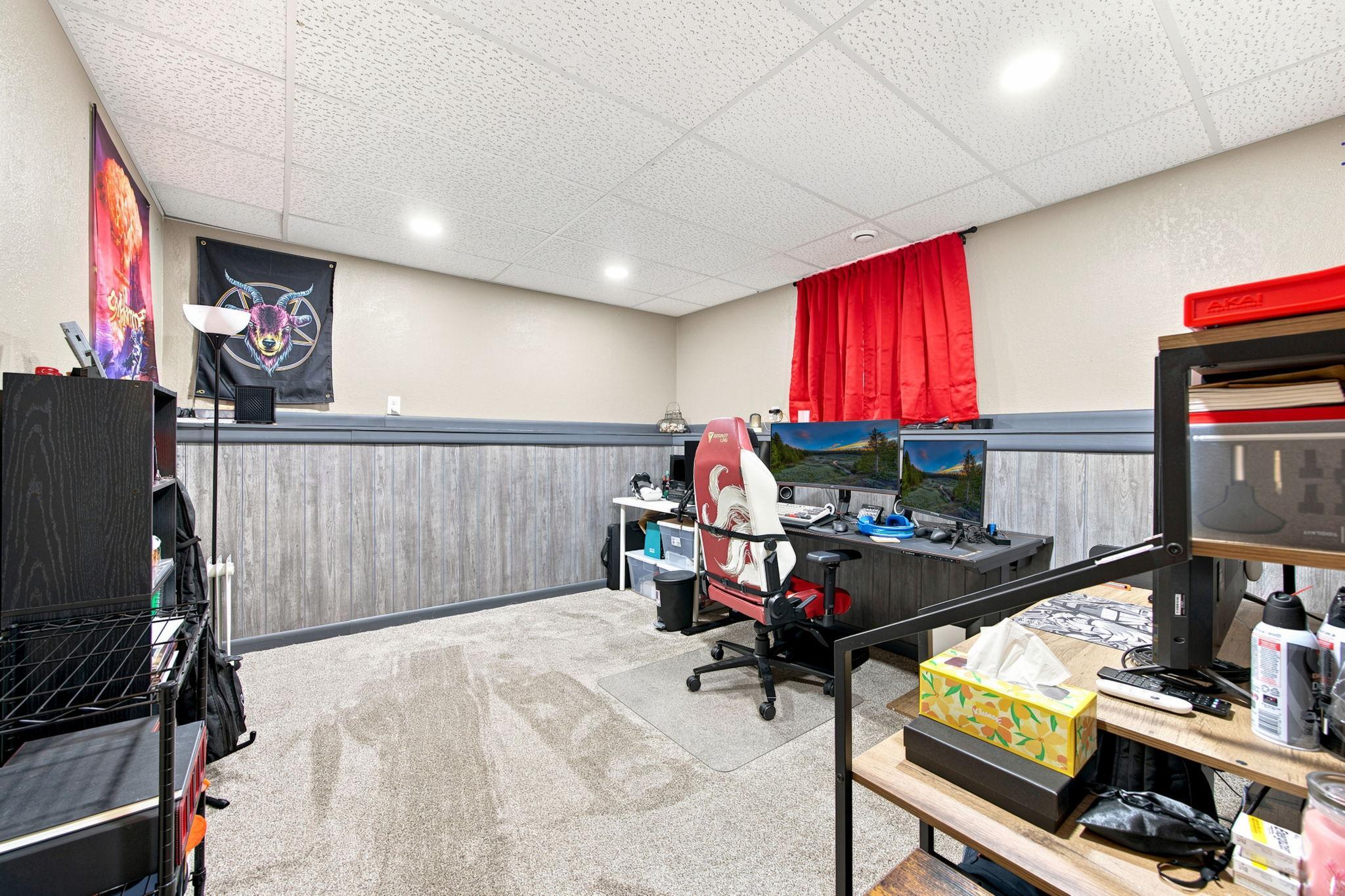 Finished lower-level room offers flexible space for an office, bedroom, or hobby space.