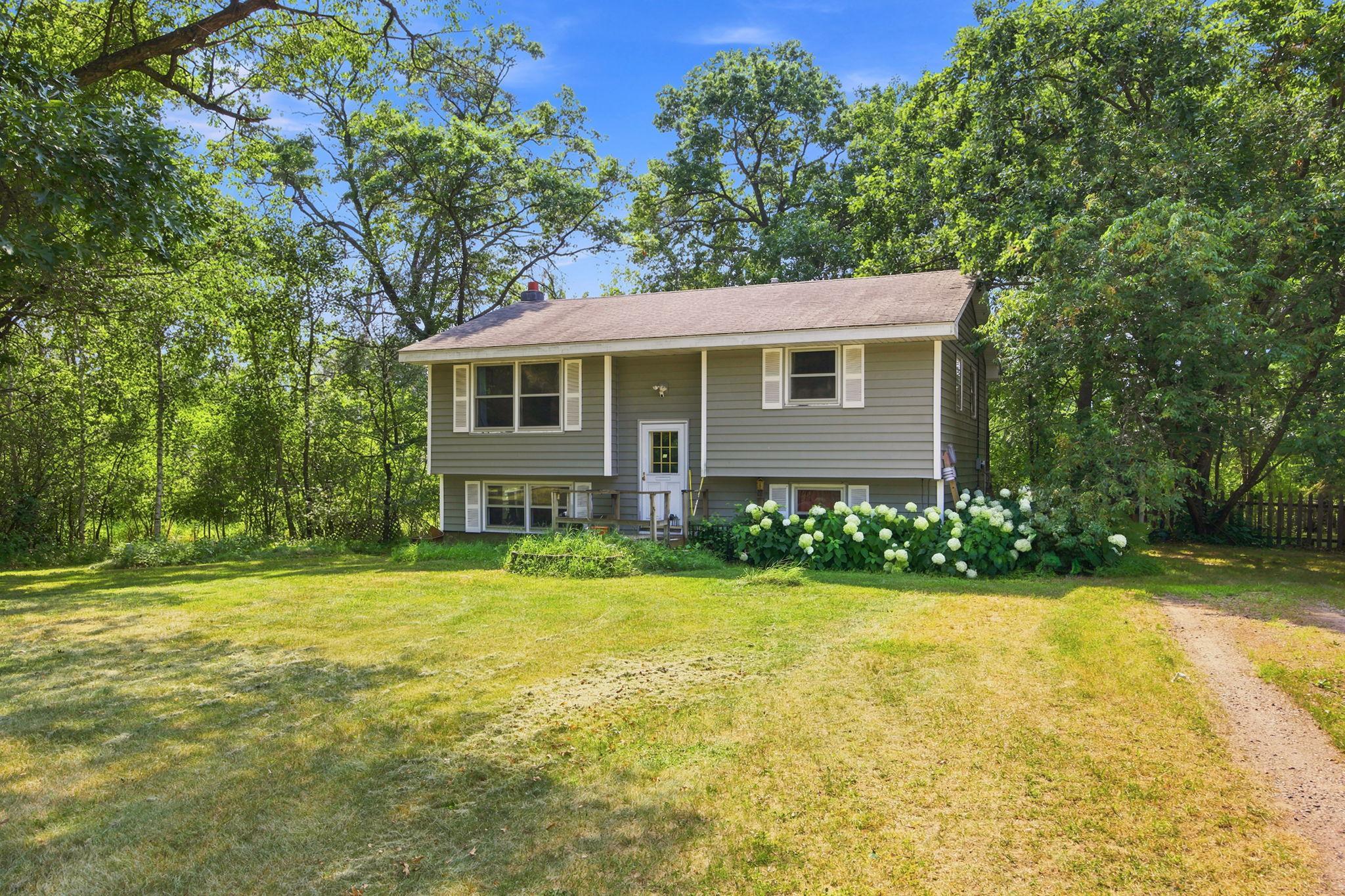Welcome to 23030 Erskine Street NE, surrounded by mature trees and a spacious yard