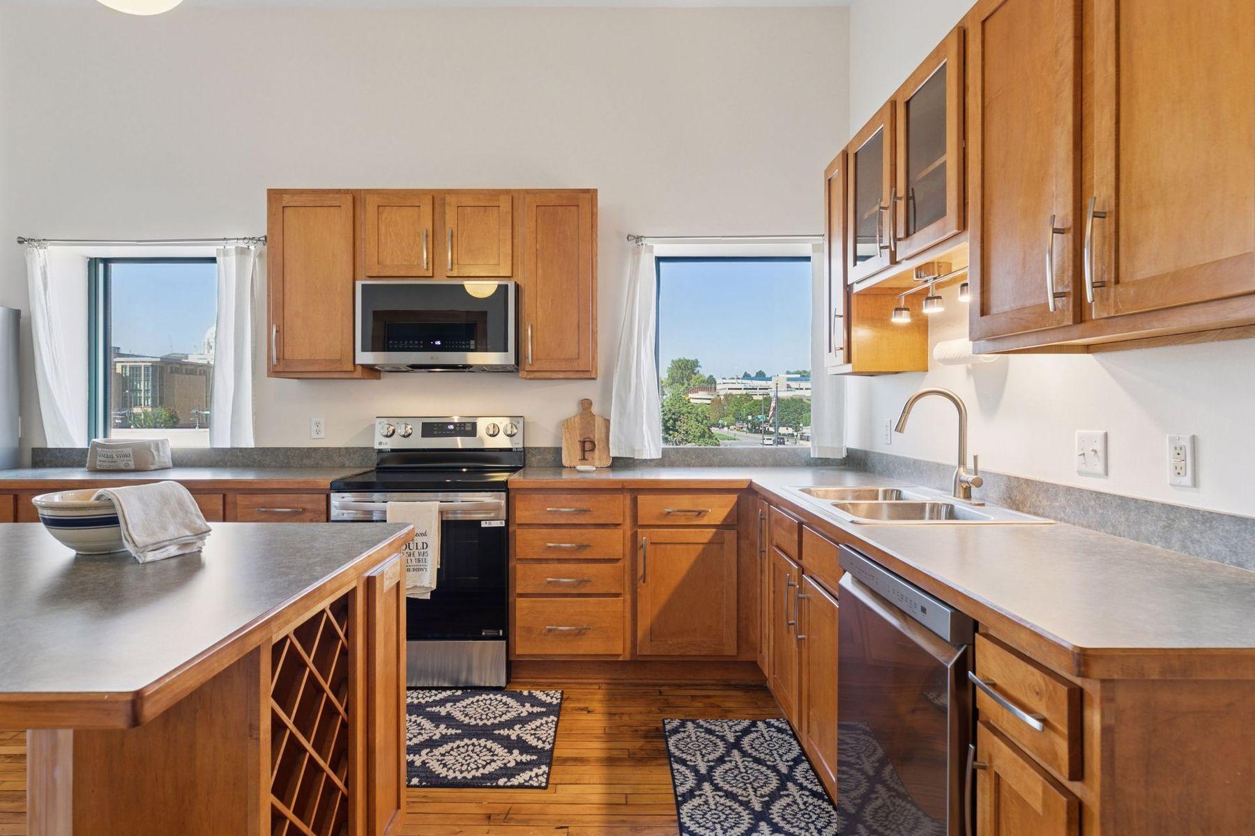 Kitchen window frames a cityscape view—enjoy natural light.