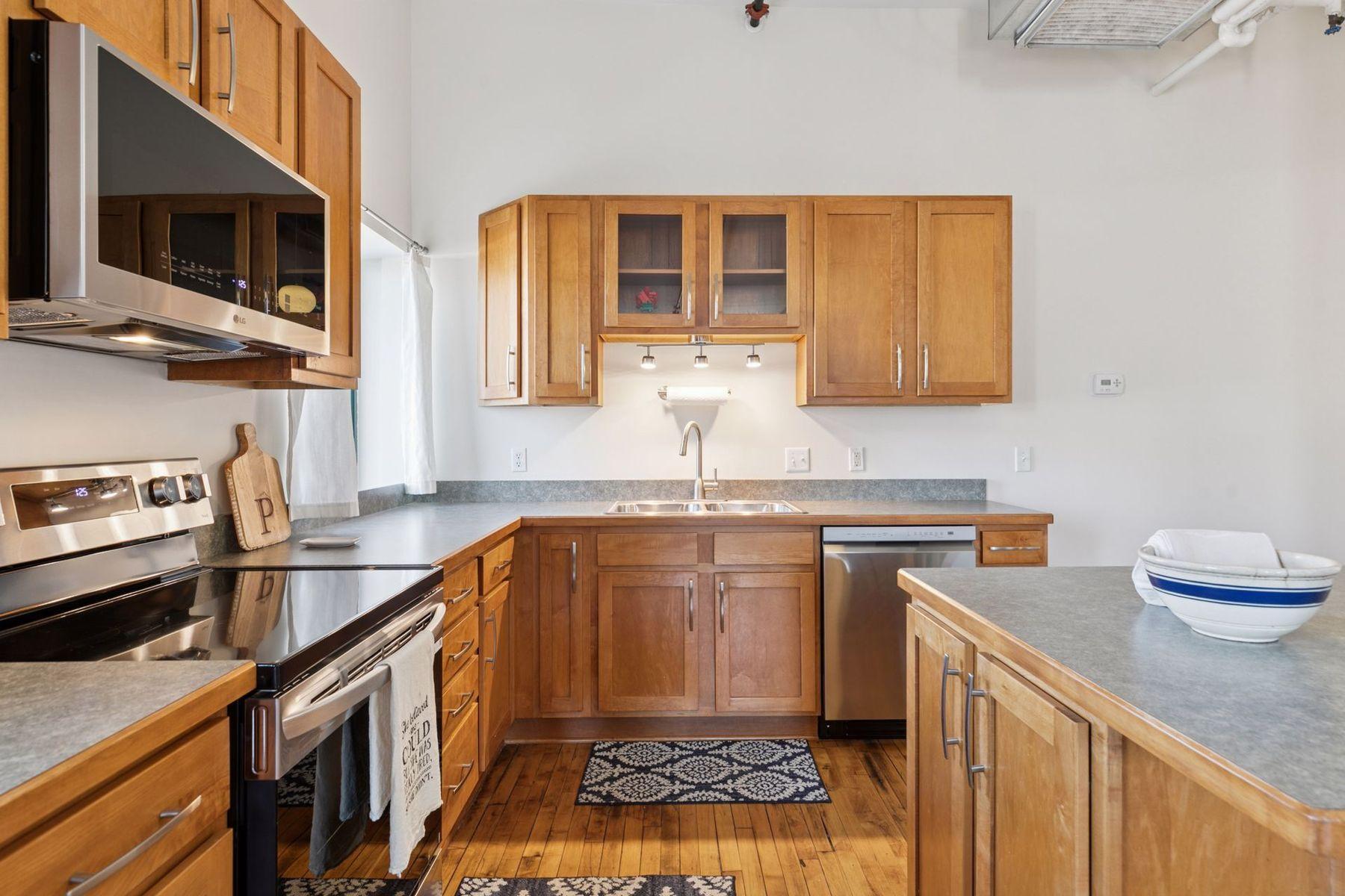 Wood cabinetry, under-cabinet lighting, —clean lines with warm, modern finishes.