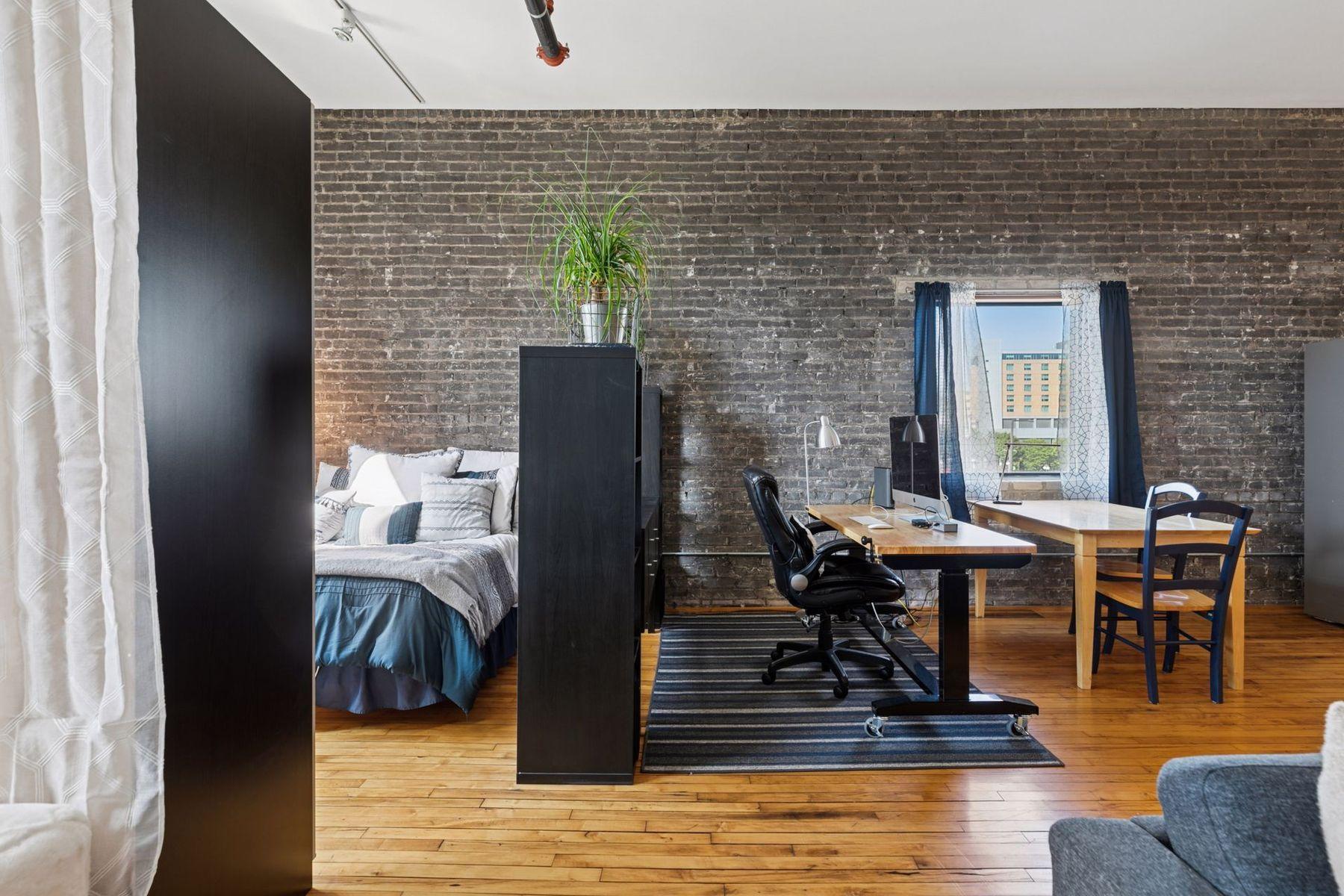 lexible layout with defined zones for living, working, and sleeping