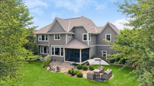Beautiful backyard for outdoor living with a screened porch and a large stamped concrete patio.